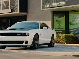 white challenger parked in front of cornerstone